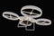 Flying quad copter drone isolated on black background