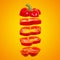 Flying red capsicum. Sliced floating bell pepper on an orange background. Levity vegetable