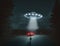 Flying saucer UFO with light beam above car on road at night, man silhouette looks to UFO