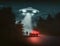 Flying saucer UFO with light beam above car on road at night, man silhouette looks to UFO