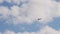 Flying silhouette small civil aircraft in sky. Double seat plane flies forward in cloudy sky. agricultural air vehicle
