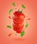 Flying sliced tomato with flowing splashes and basil leaves on red background.