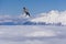 Flying snowboarder on mountains