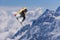 Flying snowboarder on mountains. Extreme sport