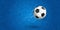 Flying soccer ball on blue background