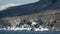 Flying Steller`s sea eagle. Snow-covered mountains on the background. Scientific name: Haliaeetus pelagicus. Natural Habitat.