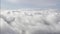 Flying through stratocumulus clouds clouds on clear blue sky background from a flying plane