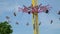 flying swing carousel attraction park people sitting fun in seats on a chain against the sky Cloverdale rodeo country