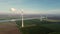 Flying towards non-rotating wind turbines in a Dutch landscape.