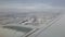 Flying and traveling abroad, bird eye view from airplane window on the jet wing on cloudy blue sky iceberg mountain snow field