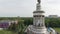 Flying up to monument of Soviet woman with wheat in hands. View to Exhibition Center VDNG in Kyiv.