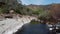 Flying upstream on cache creek running over river rocks