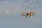 Flying vintage aircraft against a cloudy sky during an airshow