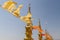 Flying and waving yellow and orange buddhist flags in thai temple with sky background