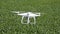 Flying white quadrocopters over a field of wheat