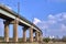 A flyover with a railway line and a chimney of a heat and power plant