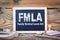 Fmla, family medical leave act. Chalkboard on a wooden background