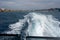 The foam created by a ferry leaving the port of Ibiza with Balearia ferrries in the background