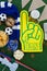 Foam hand, snacks and footballs on artificial grass