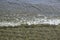 Foam of an ocean wave breaking on the shore of a beach. Background and elements design