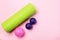 Foam Roller and Ball Roller Fitness Equipment Pink Background Myofascial Release MFR Female Hand Holds a Roller Relax and Fitness