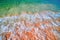 Foam Sea Surf. Turquoise wave rolls on sandy beach. Top view.
