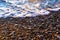 Foam sea wave rushes at pebble seashore