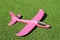 A foam throwing plane-glider lies on an artificial lawn
