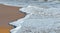 Foam waves on sandy beach