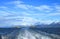 Foaming Water at the Stern of Cruise Ship with Les Eclaireurs Lighthouse and Snow Capped Mountain Ranges in the Distance, Ushuaia