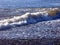 Foaming waves breaking on a pebble beach