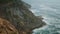 Foamy ocean cliff landscape aerial view. Deep blue sea around rocky shore island