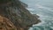 Foamy ocean cliff landscape aerial view. Deep blue sea around rocky shore island