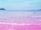 Foamy Rippled Clear Sea Wave Rolling to Pink Sand Shore Turquoise Blue Water. Beautiful Tranquil Idyllic Scenery. A cotton candy