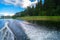 Foamy trail on the water surface behind the fast moving motorboat. The lake Seliger, Russia.