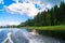 Foamy trail on the water surface behind the fast moving motorboat. The lake Seliger, Russia.