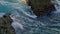 Foamy water rolling on abandoned rocks closeup. Swirling aqua at morning nature