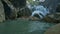 Foamy Waterfall Runs among Rocks Falling into Lake