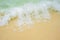 Foamy wave is incident on the yellow sand. The beach in a tropical Paradise, recreation, relaxation. Sea background