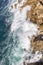 Foamy waves of the surf near the rocky shore