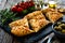 Focaccia alle olive - baked sandwich with green olives and rosemary on wooden background