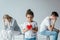 Focus of adopted african american kid holding red heart near divorced foster parents on grey