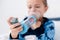 Focus of asthmatic kid using inhaler