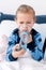 Focus of asthmatic kid using inhaler