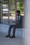 Focus of attentive african american businessman reading newspaper while sitting near office building