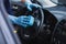 Focus of car cleaner wiping steering wheel with sponge