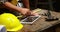 Focus on carpenter hands using tablet