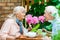 Focus of cheerful senior couple looking at each other near cups and teapot