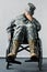 Focus of disabled military man in uniform sitting in wheelchair and covering face with hand
