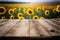 Focus empty wood table with blurred sunflower tree background.